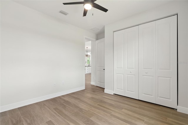 2704 Gaspar Ave, North Port, FL 34288 - unfurnished bedroom with light wood-style flooring, baseboards, a closet, and a ceiling fan