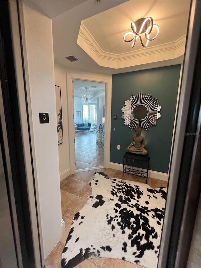 130 Riviera Dunes Way Unit 304, Palmetto, FL 34221 - corridor featuring a chandelier, a tray ceiling, and crown molding