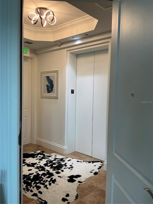 130 Riviera Dunes Way Unit 304, Palmetto, FL 34221 - hallway with a tray ceiling, crown molding, and elevator