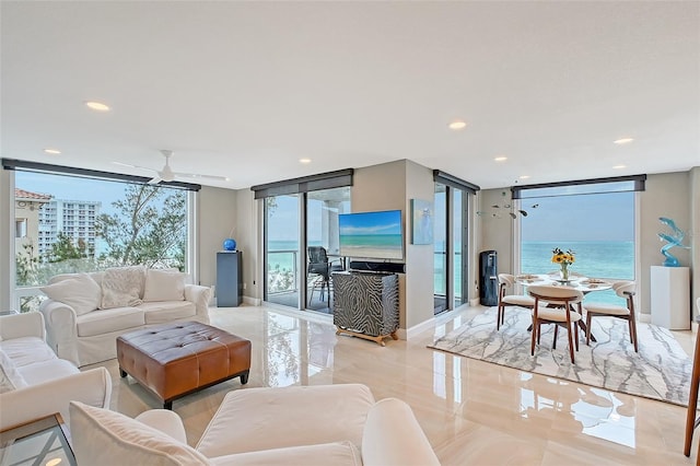 living area with expansive windows, a ceiling fan, and recessed lighting
