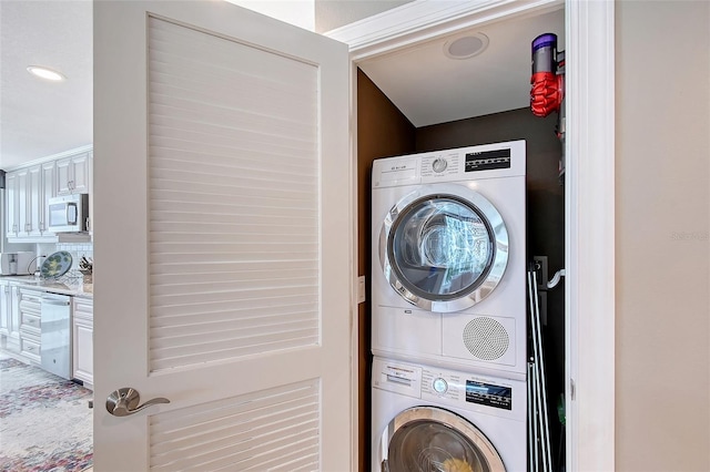 laundry area featuring estacked washer and dryer and recessed lighting