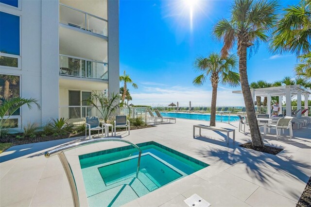 2425 Gulf Of Mexico Dr Unit 6A, Longboat Key, FL 34228 - community pool with a hot tub, a pergola, and a patio