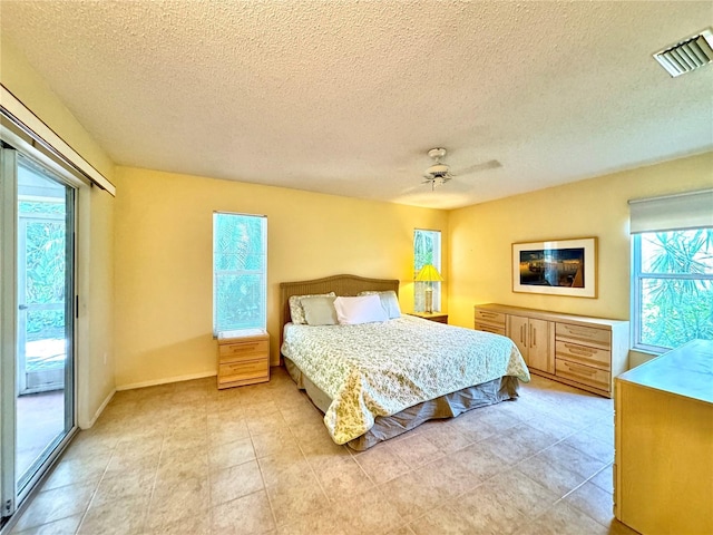 5804 Garden Lakes Fern, Bradenton, FL 34203 - bedroom with access to outside, a ceiling fan, a textured ceiling, and baseboards