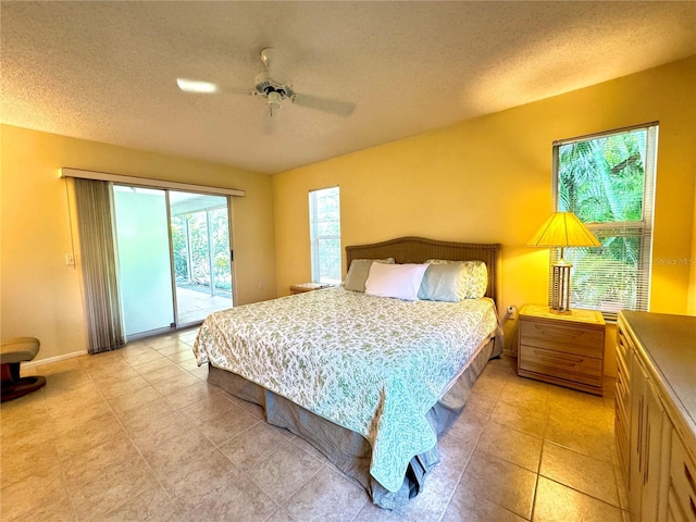 5804 Garden Lakes Fern, Bradenton, FL 34203 - bedroom featuring access to outside, a textured ceiling, ceiling fan, baseboards, and light tile patterned flooring