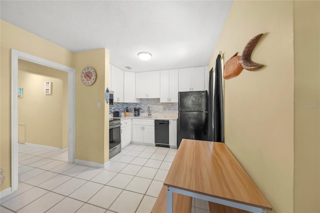 2037AND2039 Jo An Dr, Sarasota, FL 34231 - kitchen with black appliances, light tile patterned flooring, light countertops, white cabinetry, and tasteful backsplash
