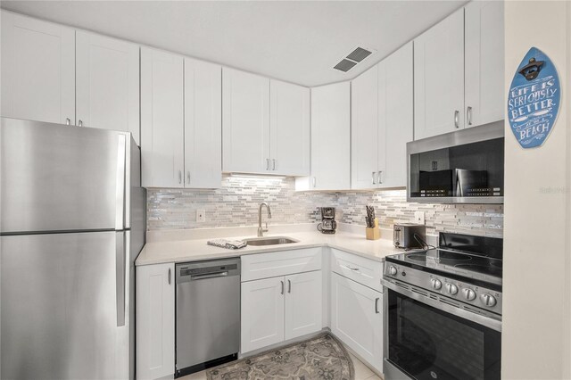2037AND2039 Jo An Dr, Sarasota, FL 34231 - kitchen with stainless steel appliances, white cabinets, and light countertops
