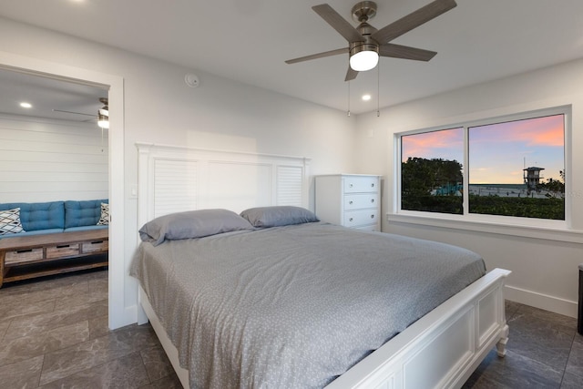 bedroom featuring baseboards, dark stone finish floors, recessed lighting, and ceiling fan