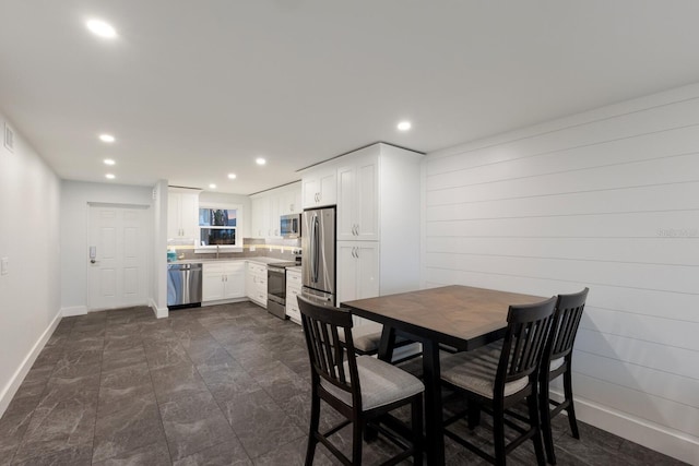 dining area with baseboards and recessed lighting