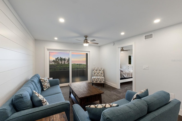 living room with recessed lighting, ceiling fan, dark colored carpet, and baseboards