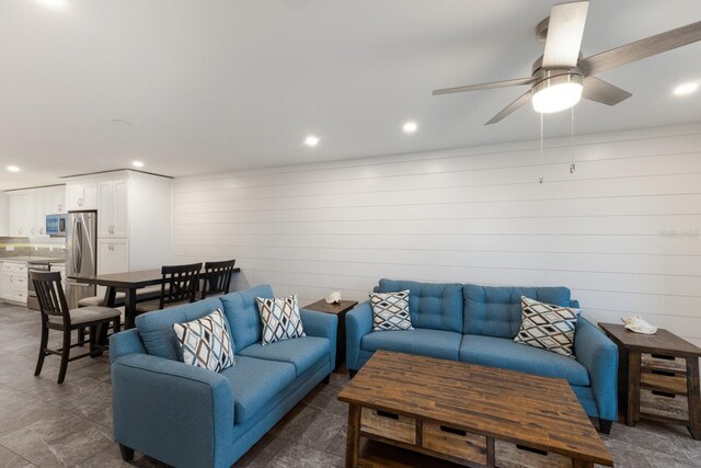 living room with ceiling fan and recessed lighting