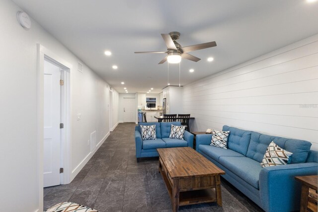 living area featuring recessed lighting, a ceiling fan, and baseboards