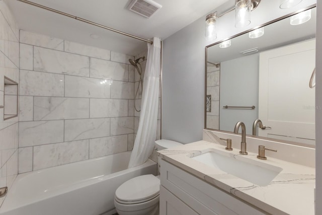 full bath featuring toilet, shower / bath combo with shower curtain, and vanity