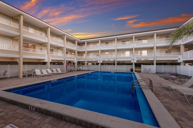community pool featuring fence and a patio area