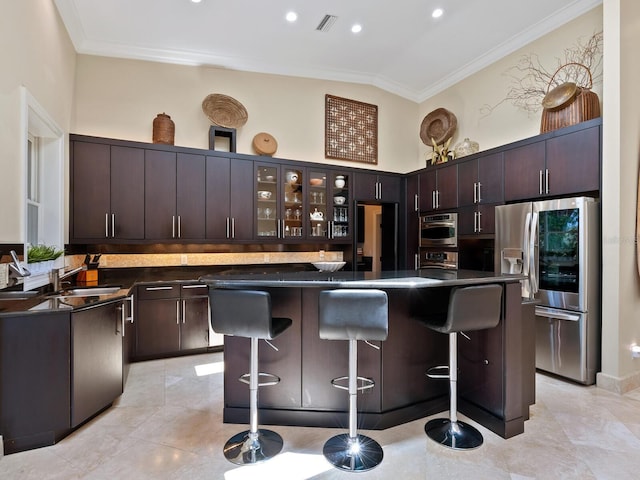 7320 Melaleuca Way, Siesta Key, FL 34242 - kitchen with stainless steel refrigerator with ice dispenser, dark countertops, ornamental molding, a kitchen breakfast bar, and dark brown cabinetry