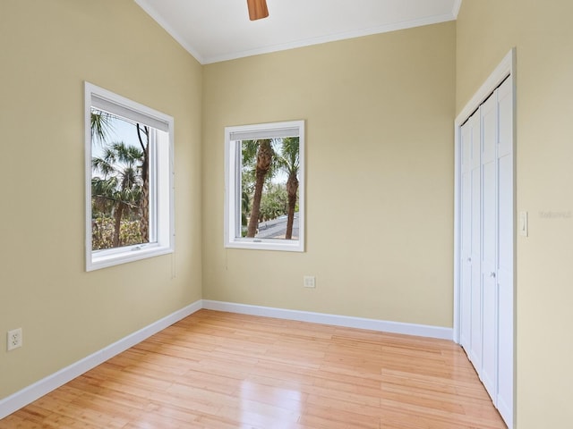 7320 Melaleuca Way, Siesta Key, FL 34242 - unfurnished bedroom featuring light wood-style floors, ornamental molding, baseboards, a closet, and ceiling fan