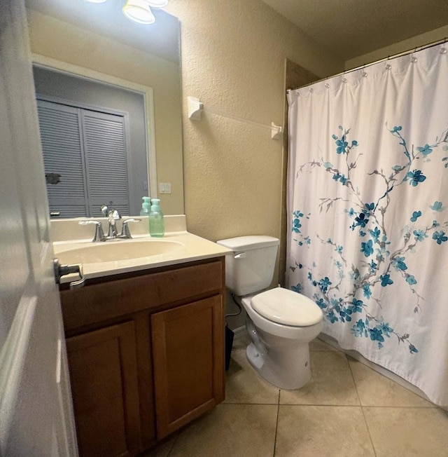 7911 Grand Estuary Trl Unit 201, Bradenton, FL 34212 - bathroom with a textured wall, toilet, vanity, tile patterned floors, and a shower with shower curtain