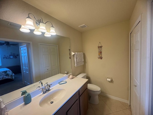 7911 Grand Estuary Trl Unit 201, Bradenton, FL 34212 - bathroom with vanity, toilet, a textured ceiling, ensuite bath, and tile patterned floors