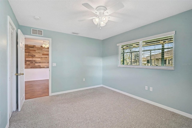 602 Park Cir, Bradenton, FL 34207 - carpeted spare room with a ceiling fan, a textured ceiling, baseboards, and a smoke detector