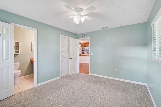 602 Park Cir, Bradenton, FL 34207 - unfurnished bedroom featuring carpet, a closet, baseboards, and a textured ceiling