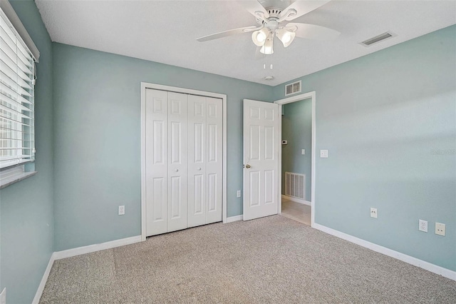 602 Park Cir, Bradenton, FL 34207 - unfurnished bedroom featuring baseboards, carpet, a closet, and ceiling fan