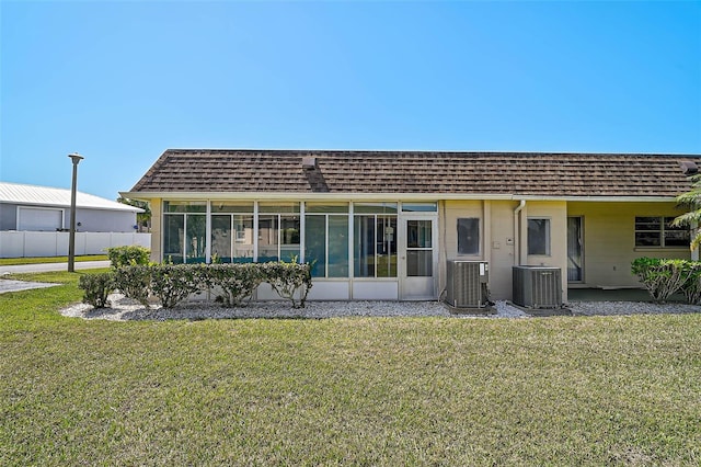 602 Park Cir, Bradenton, FL 34207 - rear view of property with cooling unit, a sunroom, and a shingled roof