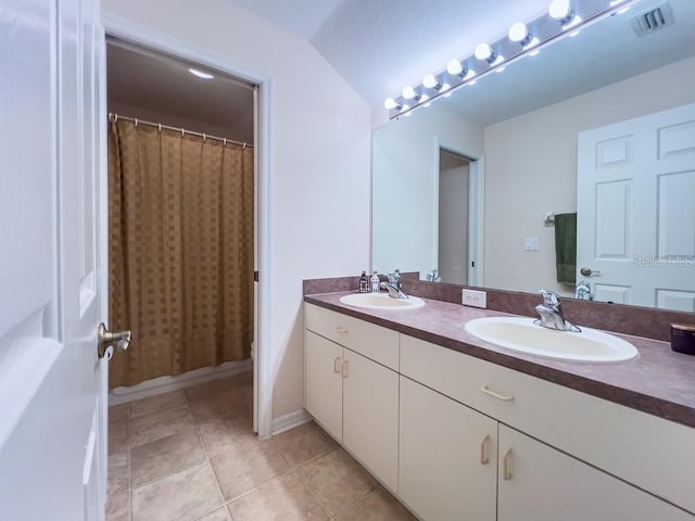 full bathroom with tile patterned flooring and double vanity