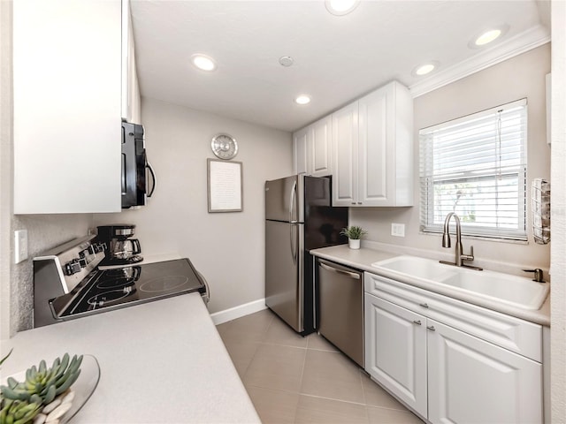 5669 Midnight Pass Rd Unit 308, Sarasota, FL 34242 - kitchen featuring appliances with stainless steel finishes, a sink, white cabinetry, baseboards, and light countertops