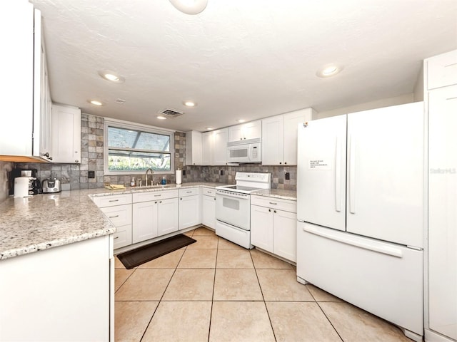 5669 Midnight Pass Rd Unit 308, Sarasota, FL 34242 - kitchen featuring white appliances, a sink, backsplash, light tile patterned floors, and white cabinetry