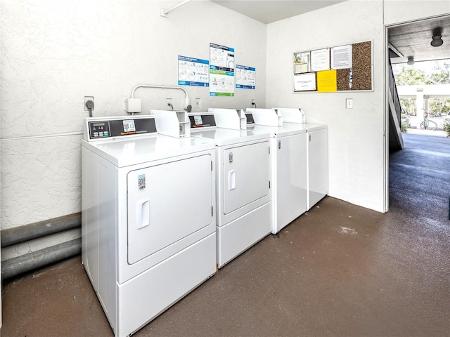 5669 Midnight Pass Rd Unit 308, Sarasota, FL 34242 - communal laundry room featuring washer and clothes dryer and a textured wall