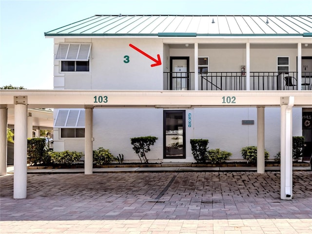 5669 Midnight Pass Rd Unit 308, Sarasota, FL 34242 - view of building exterior with covered parking