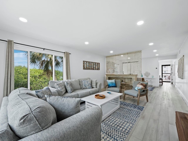 living area with recessed lighting and light wood-type flooring