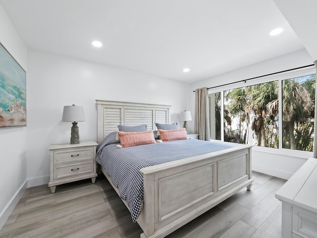 bedroom featuring light wood-type flooring and recessed lighting