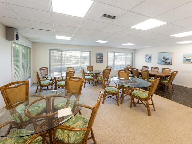 dining room featuring a paneled ceiling and baseboards