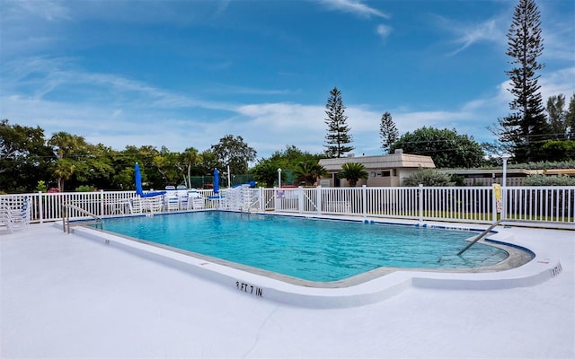 community pool featuring fence