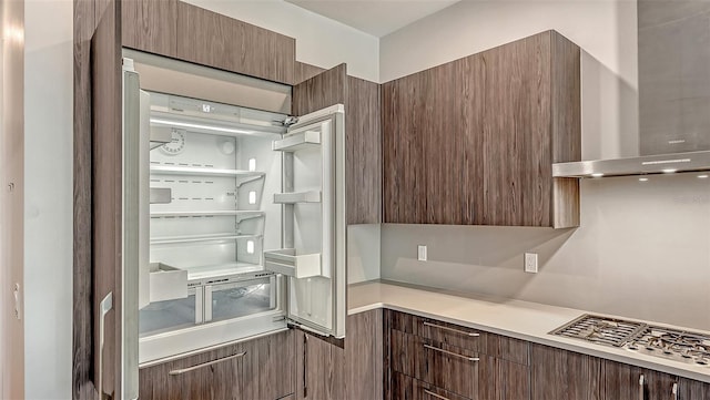 33 S Palm Ave Unit 1303, Sarasota, FL 34236 - kitchen featuring wall chimney range hood, modern cabinets, light countertops, fridge, and dark brown cabinets