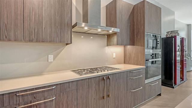 33 S Palm Ave Unit 1303, Sarasota, FL 34236 - kitchen with wall chimney exhaust hood, appliances with stainless steel finishes, light countertops, and modern cabinets