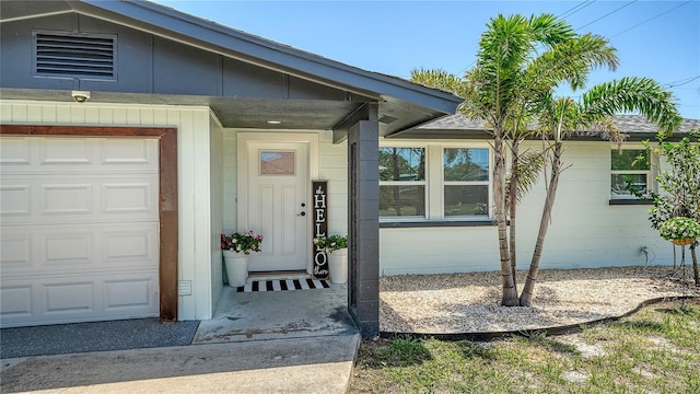 1227 Porpoise Rd, Venice, FL 34293 - doorway to property featuring concrete block siding and an attached garage