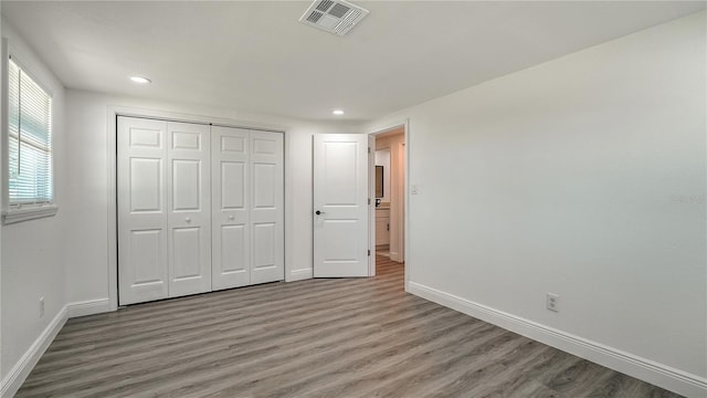 1227 Porpoise Rd, Venice, FL 34293 - unfurnished bedroom with wood finished floors, baseboards, recessed lighting, and a closet