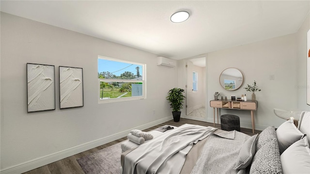 1227 Porpoise Rd, Venice, FL 34293 - bedroom with a wall unit AC, wood finished floors, and baseboards