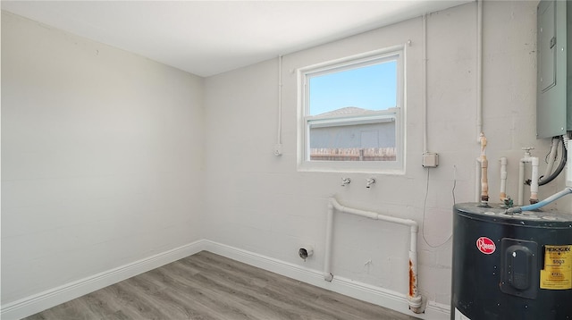 1227 Porpoise Rd, Venice, FL 34293 - laundry room featuring water heater, wood finished floors, baseboards, and electric panel