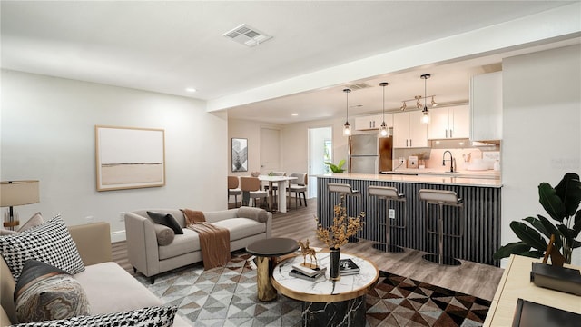 1227 Porpoise Rd, Venice, FL 34293 - living area with light wood finished floors, recessed lighting, and baseboards