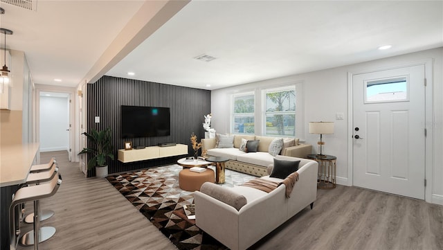 1227 Porpoise Rd, Venice, FL 34293 - living area featuring wood finished floors, recessed lighting, an accent wall, and baseboards