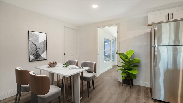 1227 Porpoise Rd, Venice, FL 34293 - dining area with baseboards, light wood-style flooring, and recessed lighting