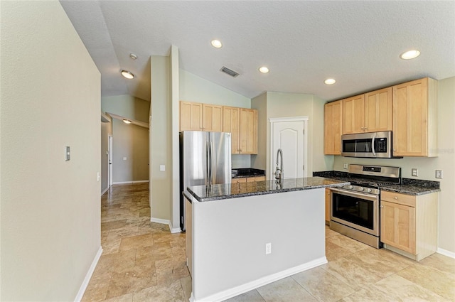 kitchen featuring stainless steel appliances, light brown cabinets, dark stone countertops, baseboards, and recessed lighting