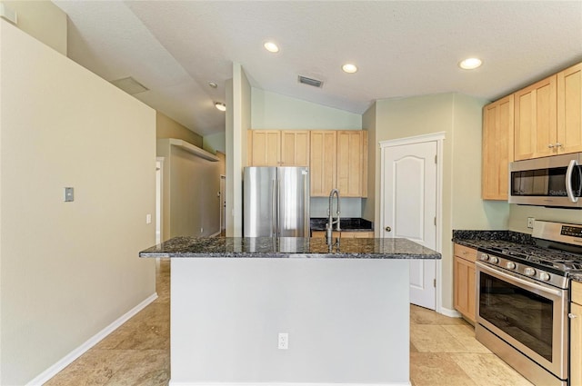 kitchen with stainless steel appliances, light brown cabinetry, dark stone countertops, recessed lighting, and lofted ceiling