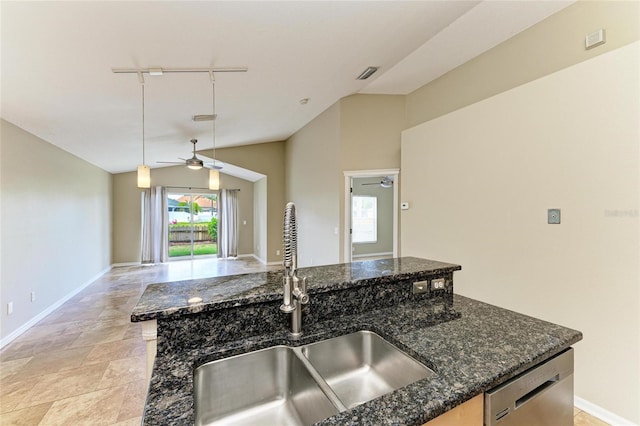 kitchen with a sink, a ceiling fan, stainless steel dishwasher, vaulted ceiling, and rail lighting