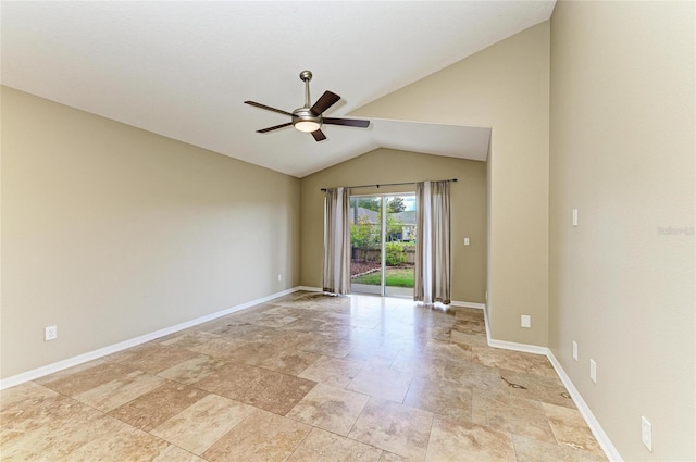 empty room with a ceiling fan, vaulted ceiling, light stone finish flooring, and baseboards