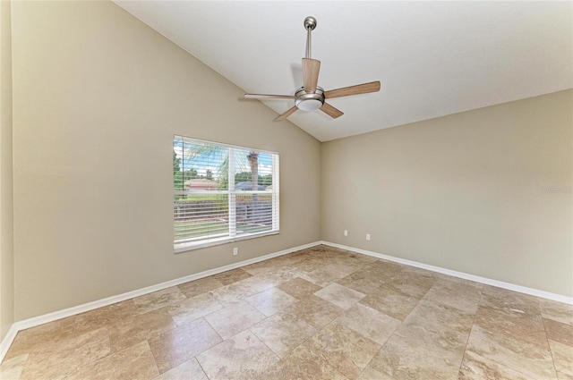 spare room featuring a ceiling fan, baseboards, vaulted ceiling, and light stone finish flooring