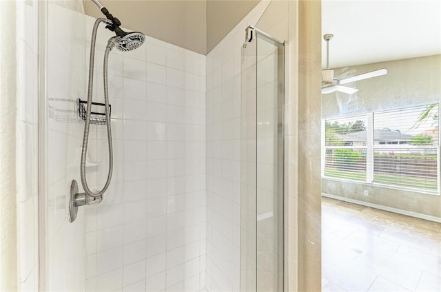 full bathroom featuring a stall shower and ceiling fan