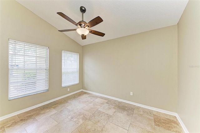 unfurnished room featuring a ceiling fan, vaulted ceiling, and baseboards